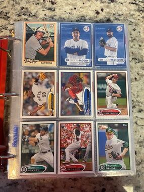 Binder full of a baseball Card collection with stars and Rookies